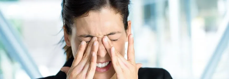 Woman rubbing her eyes because of dry eye irritation
